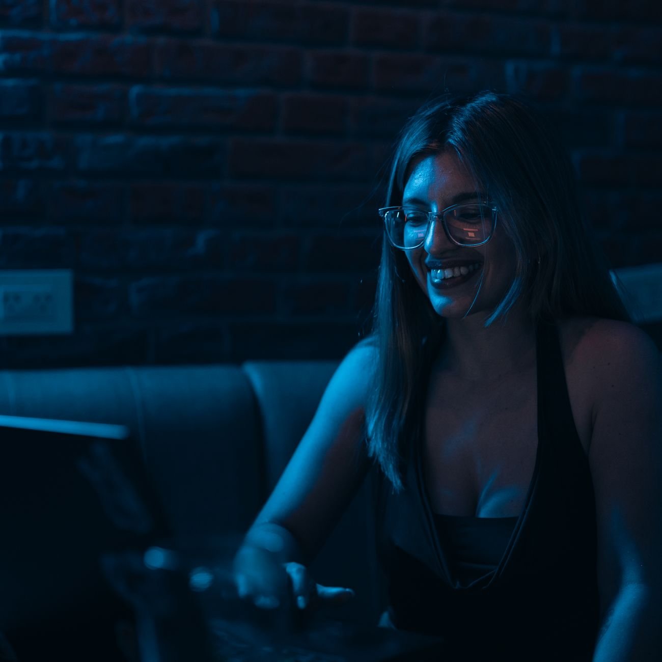 Young professional woman smiling at laptop