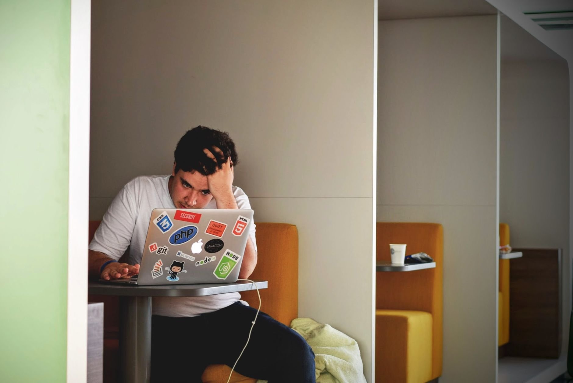 Man stressed at laptop during job search